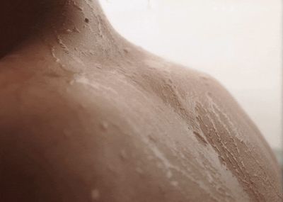 a close up of a person's back with water on it