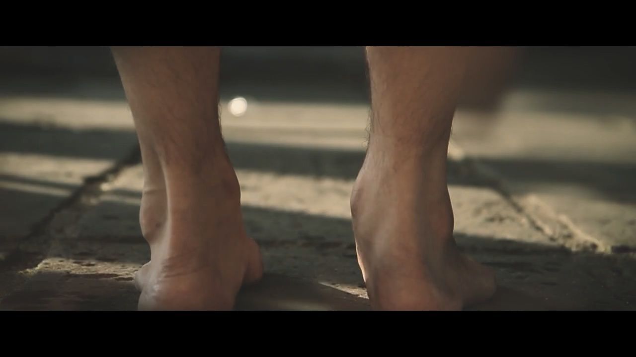 a close up of a person's bare feet on the ground