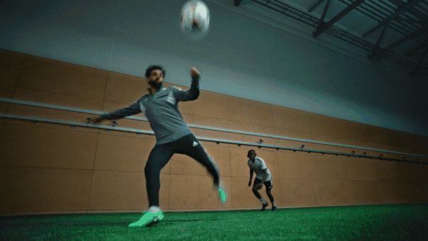 two men are playing with a soccer ball