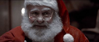 a man in a santa suit with glasses and a beard