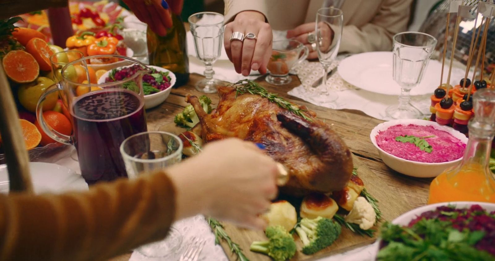 a group of people sitting around a table with food