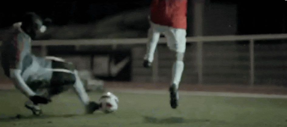 two men are playing soccer on a field