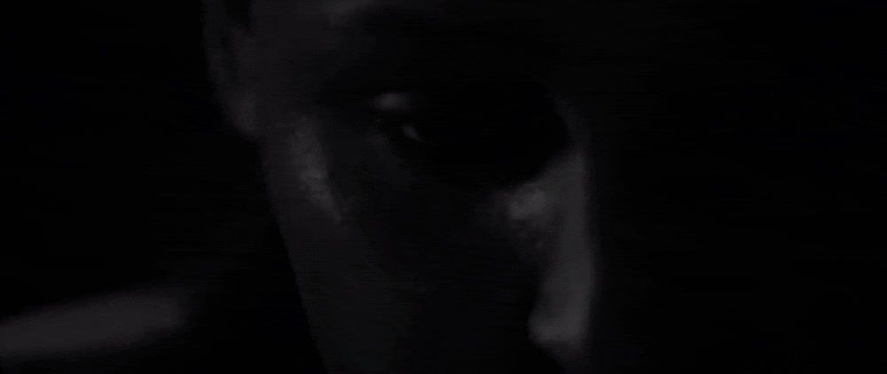 a blurry image of a man's face in the dark