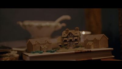 a book with a miniature house on top of it