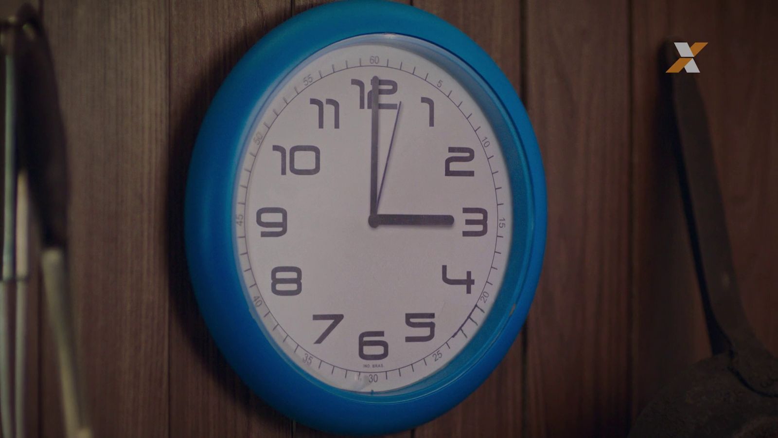 a blue and white clock hanging on a wall