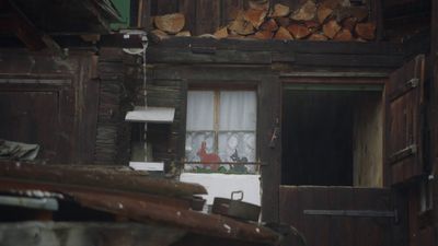 a room with a window and a bunch of wood stacked on top of it