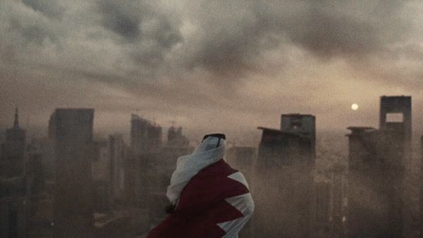 a person in a red and white cloak standing in front of a cityscape