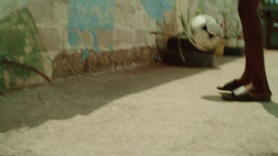 a person standing in front of a wall with a soccer ball