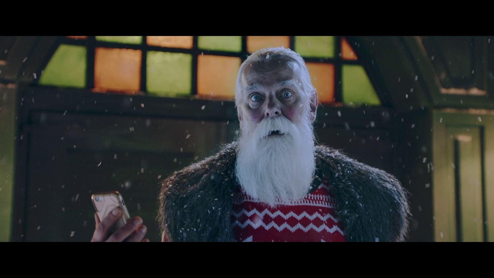 a man with a long white beard wearing an ugly sweater