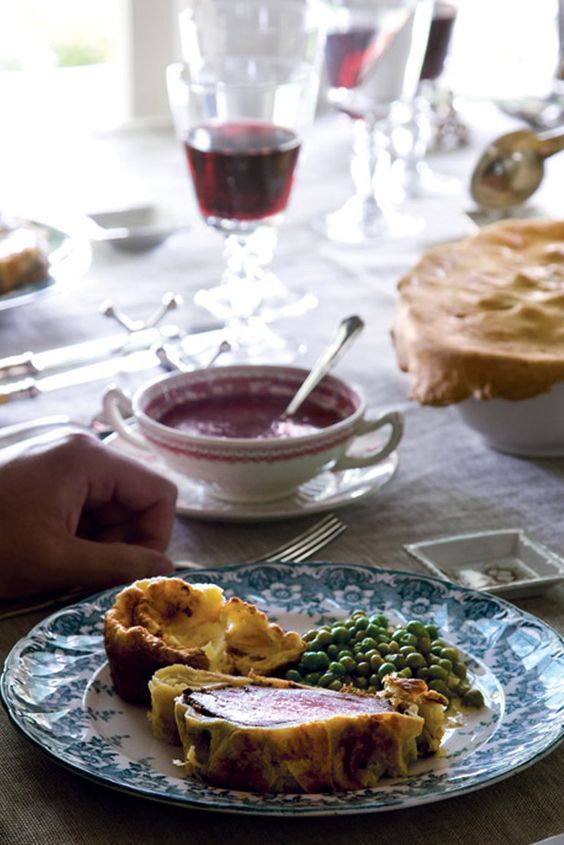 a plate of food on a table with a glass of wine