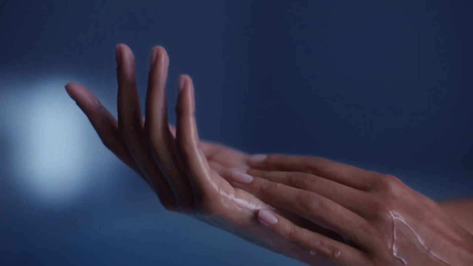 a woman's hands with a lot of soap on them