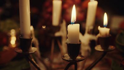 a group of lit candles sitting on top of a table