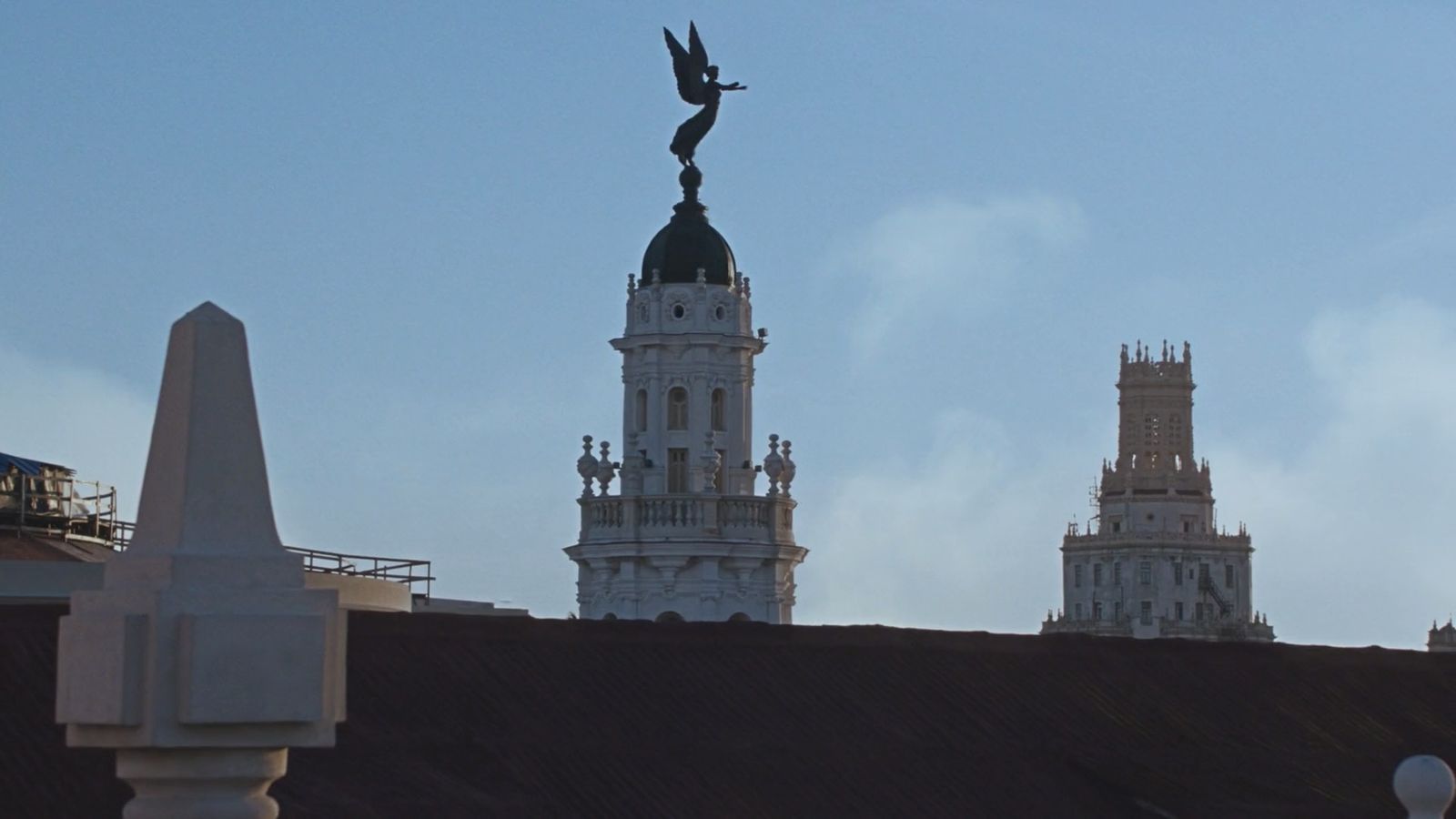 a statue of a bird on top of a building