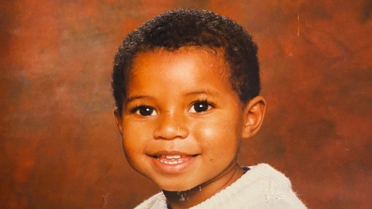 a young boy is smiling for a picture