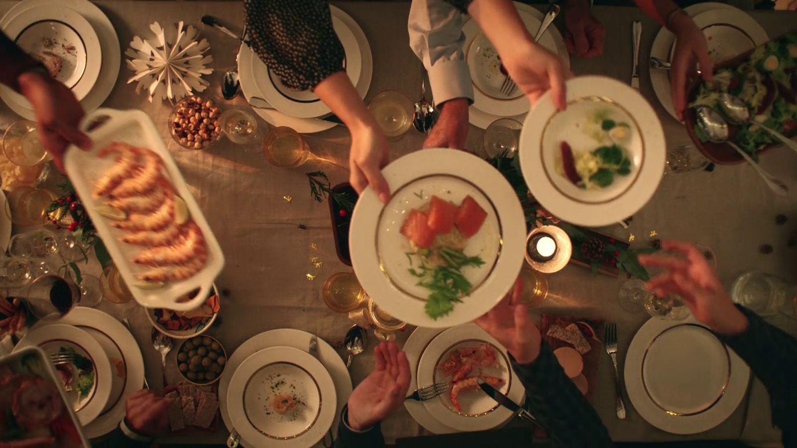 a group of people holding plates with food on them