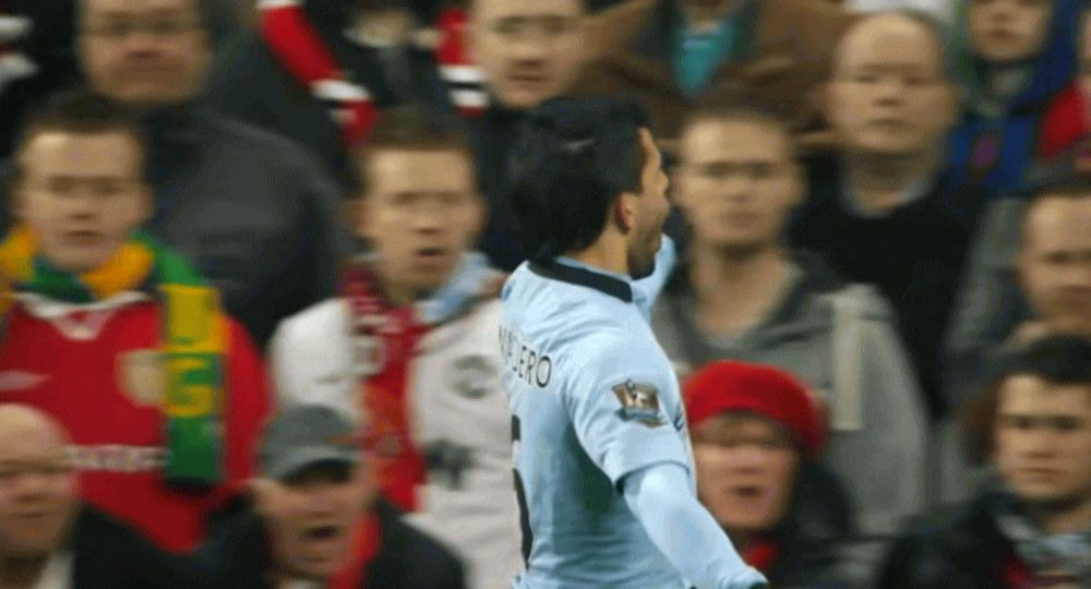 a man in a blue uniform standing in front of a crowd