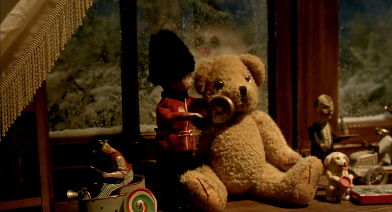 a teddy bear sitting in front of a window