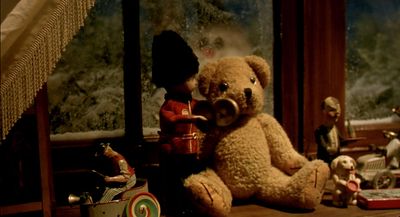 a teddy bear sitting in front of a window