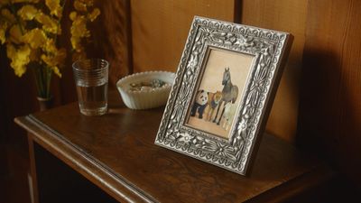 a picture frame sitting on top of a wooden table