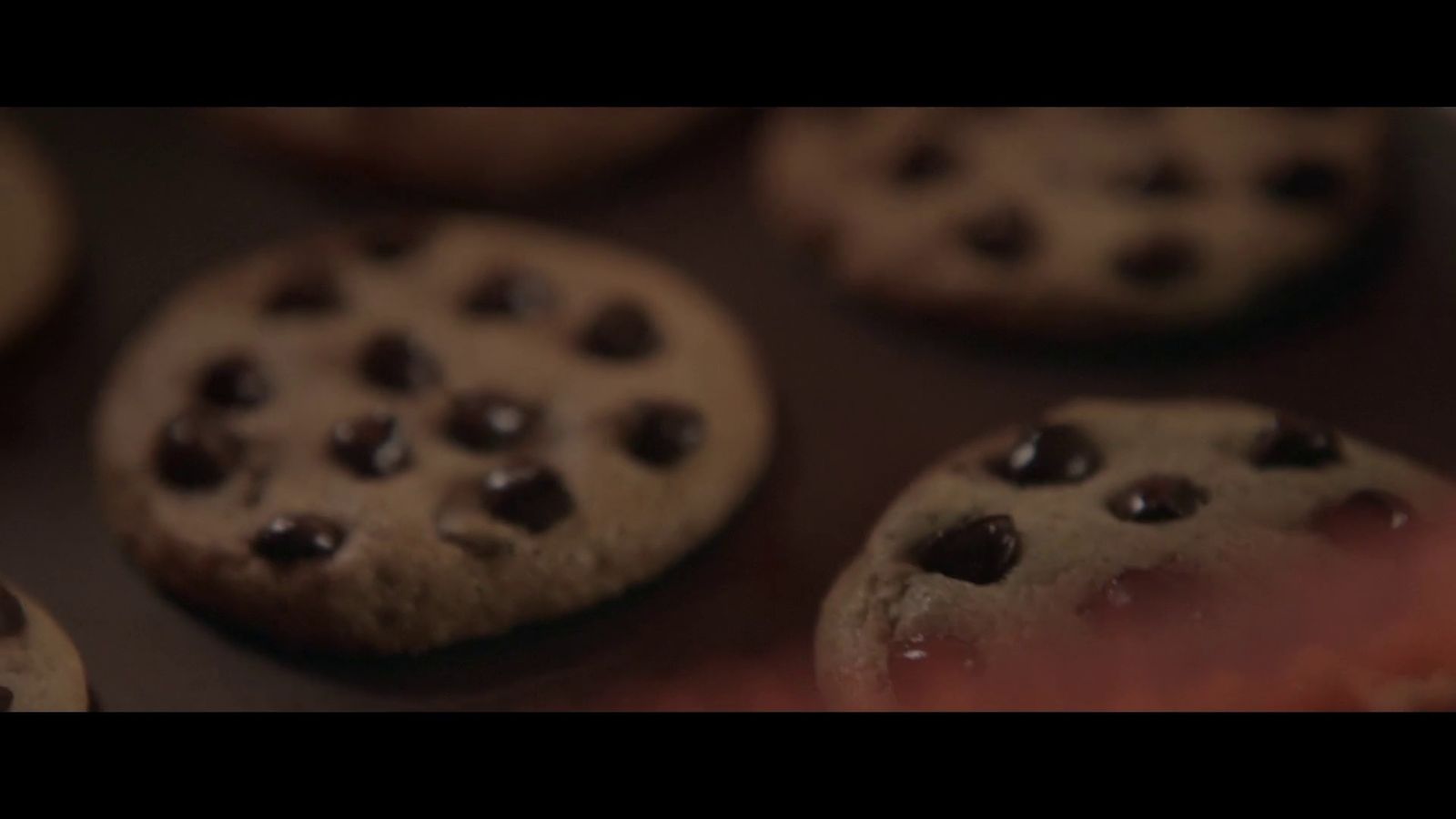 a close up of chocolate chip cookies on a baking sheet