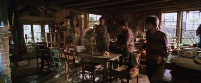 a group of people standing around a kitchen