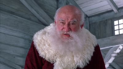 a man with a long white beard wearing a red outfit