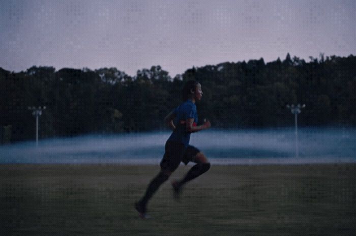 a man running in a field at night