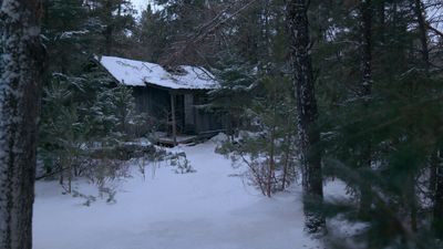 a cabin in the woods is covered in snow