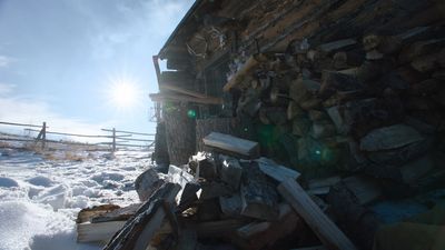 a pile of wood sitting next to a building