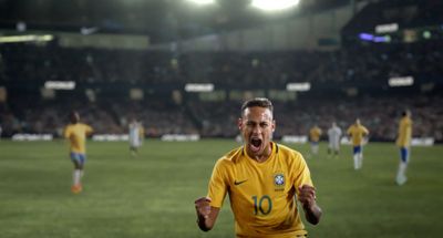 a soccer player celebrates a goal in front of a crowd