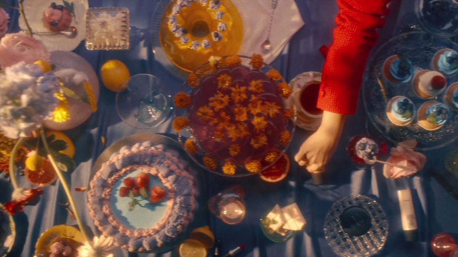 a table topped with lots of cake covered in frosting