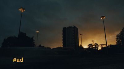 a dark street with street lights and a dark sky in the background