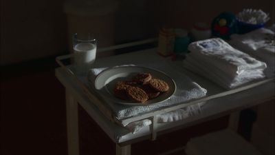 a plate of cookies and a glass of milk on a table