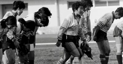 a group of young men standing next to each other on a field