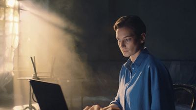 a woman sitting at a desk with a laptop