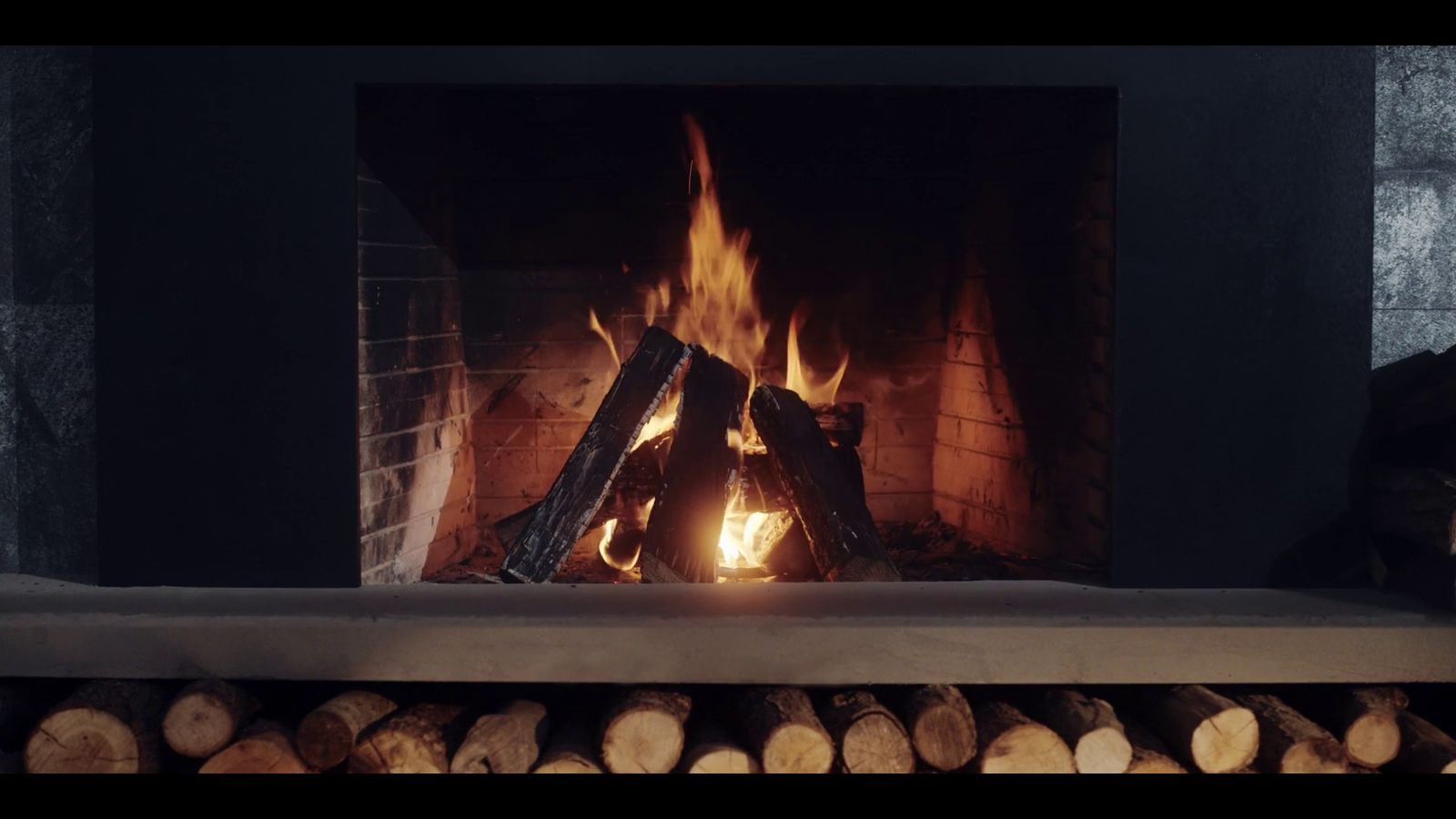 a fire is burning in a fireplace with logs