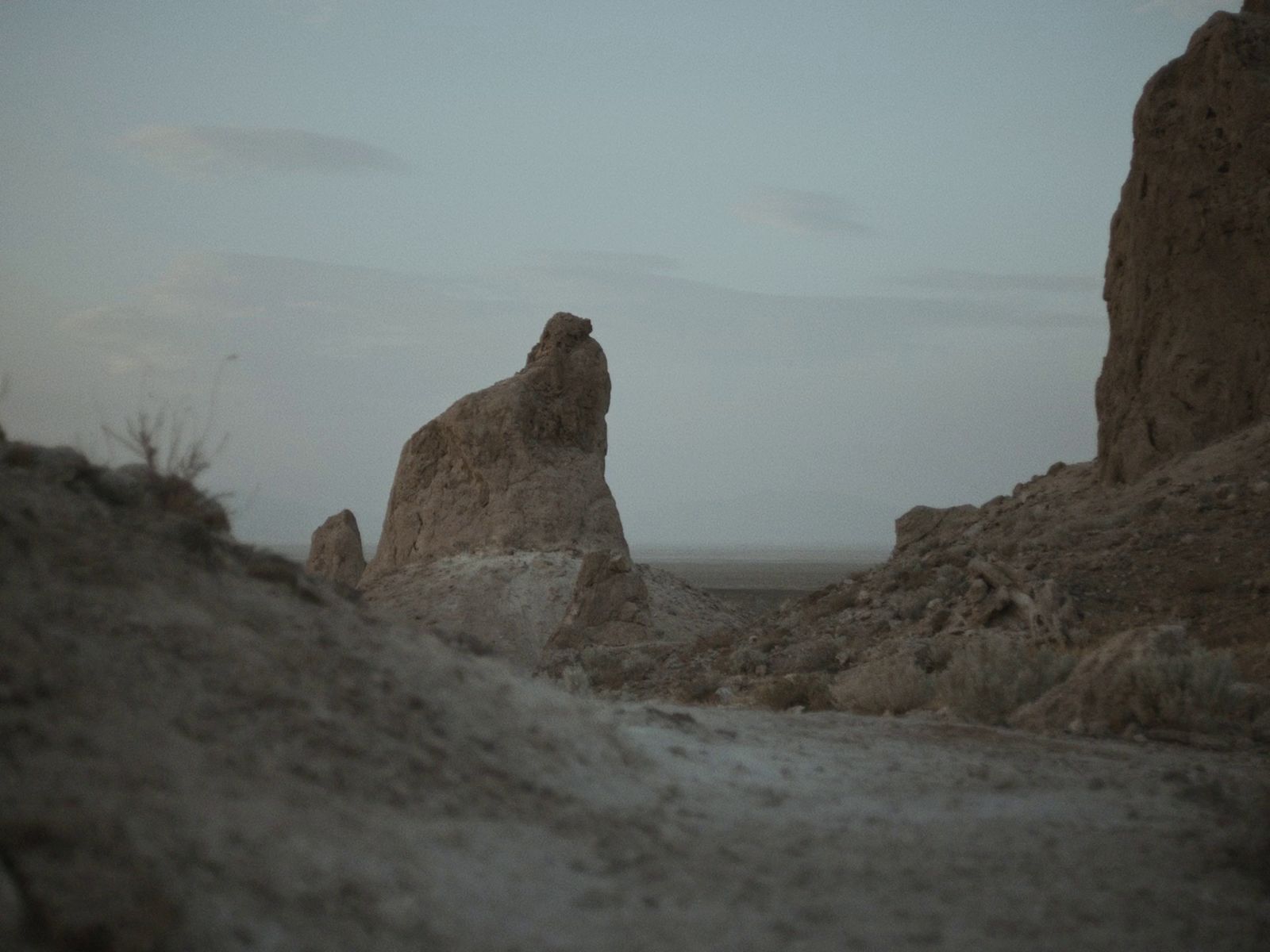 a large rock formation in the middle of a desert