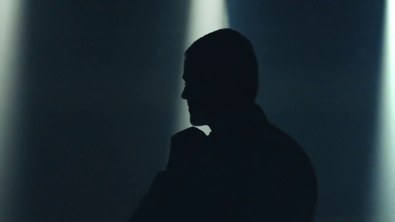 a silhouette of a man in a dark room