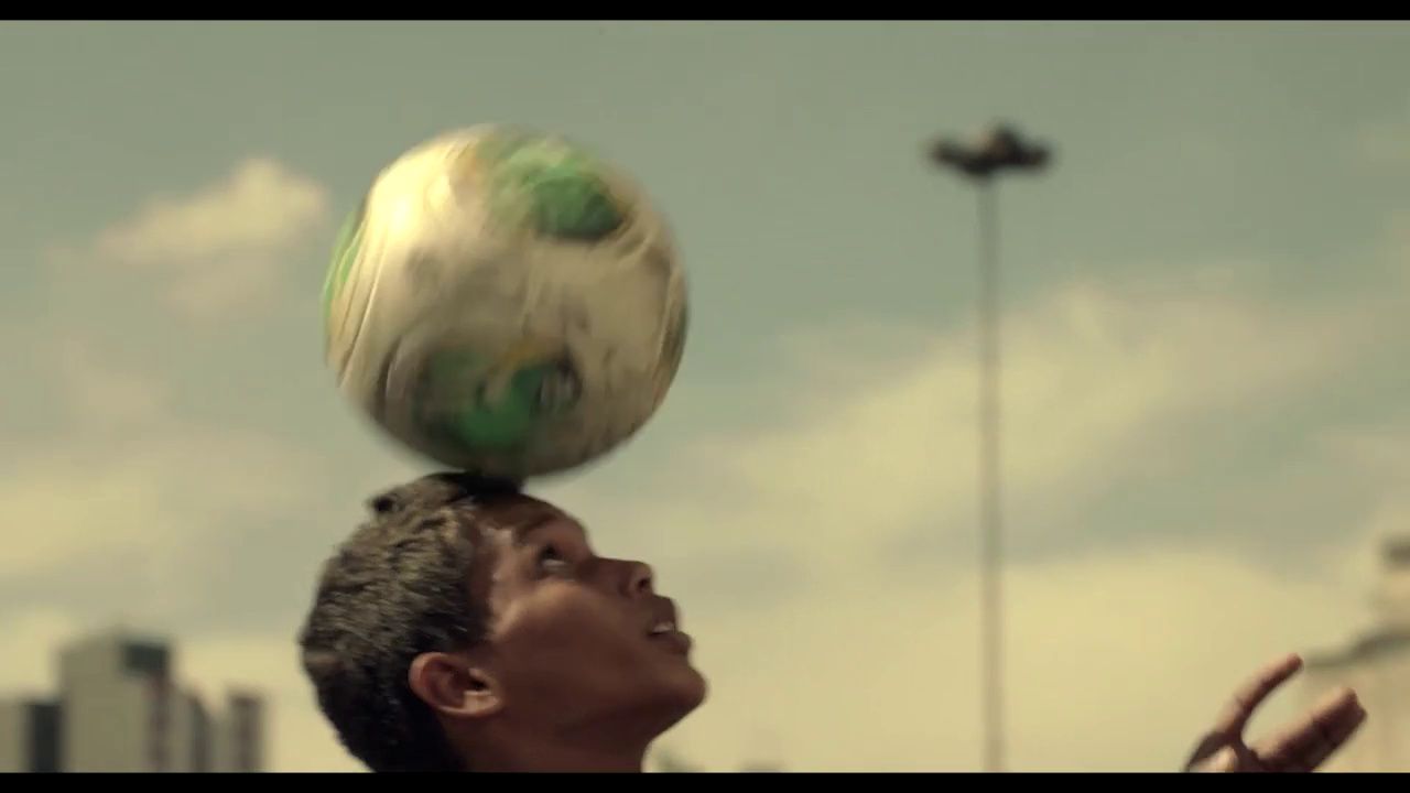 a man balancing a soccer ball on his head