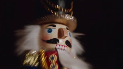 a close up of a nutcracker wearing a crown