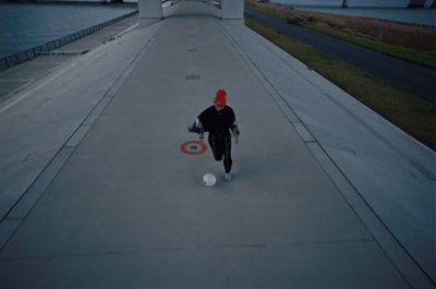 a person in a red hat is kicking a soccer ball