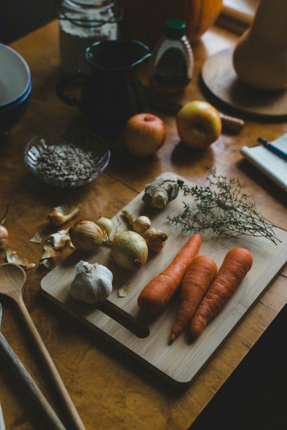 a cutting board topped with carrots and onions