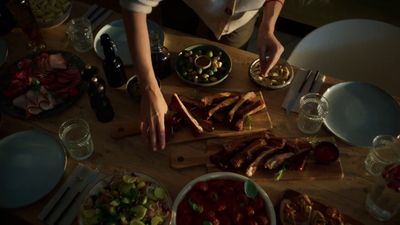 a person preparing food on a wooden table