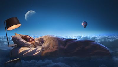 a woman is sleeping in a bed in the sky