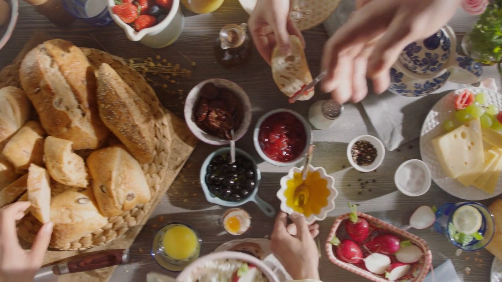 a group of people sitting around a table eating food