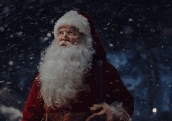 a man dressed as santa claus in the snow