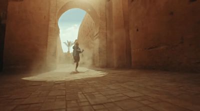 a man running through a tunnel in a desert