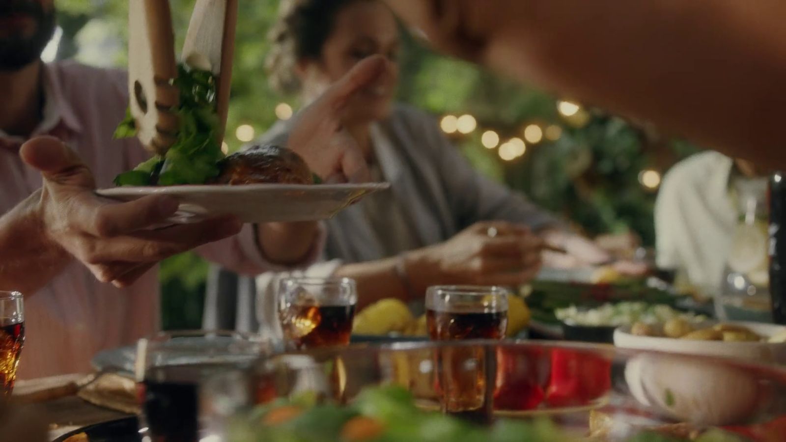 a group of people sitting around a table eating food