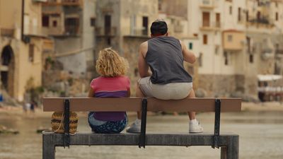 a man and a woman sitting on a bench