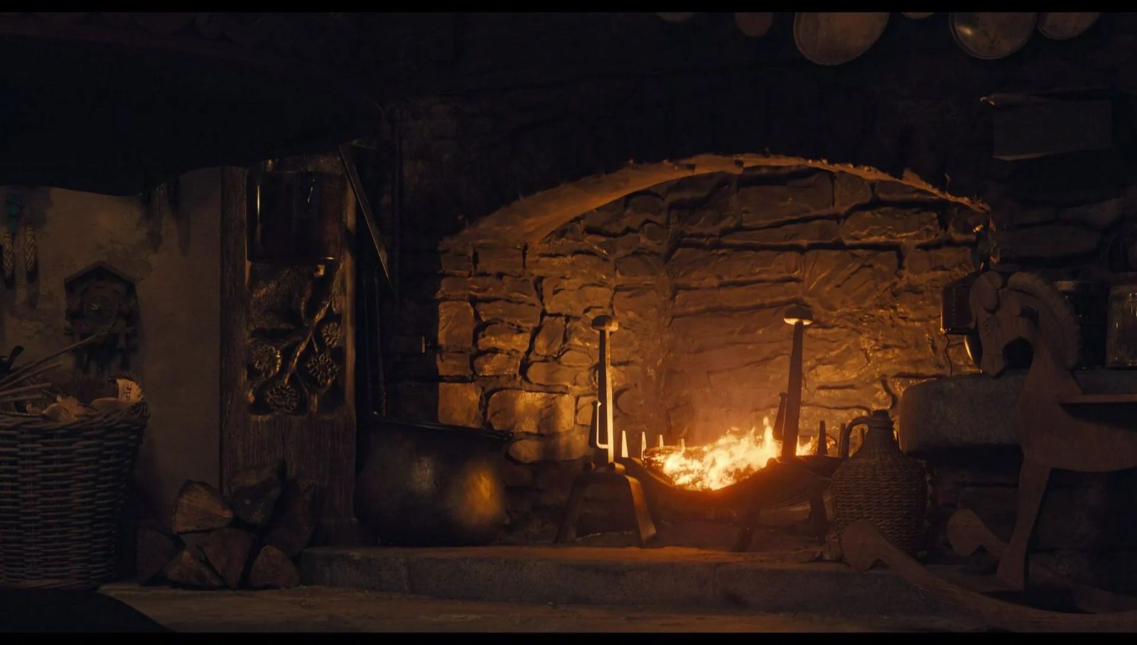 a fire in a stone fireplace in a room